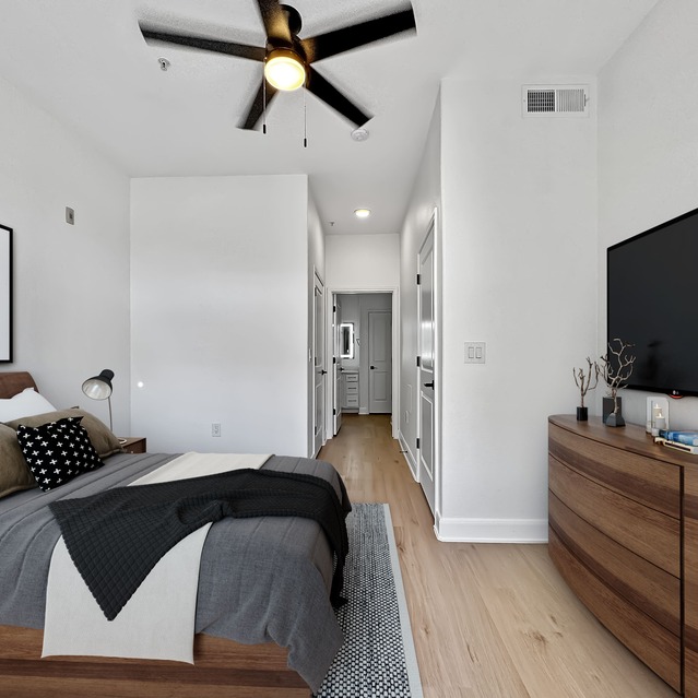 Instrata Upper Kirby - Minimalist bedroom with dresser and ceiling fan